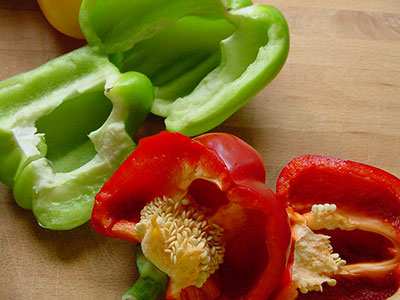 Green and red bell pepper on counter