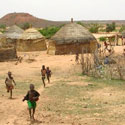 Village children run to meet Ken Kilner as he arrives in Africa