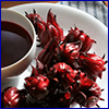 roselle fruit next to cup of tea