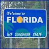 Blue highway sign that reads Welcome to Florida, the Sunshine State