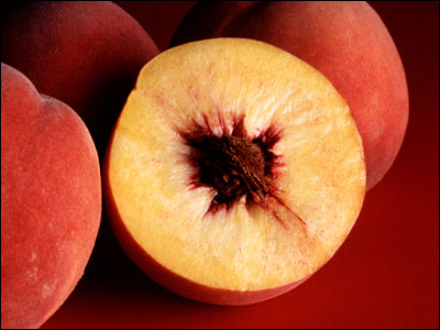 Peach cut open to reveal pit