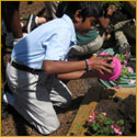 Student planting potted flowers